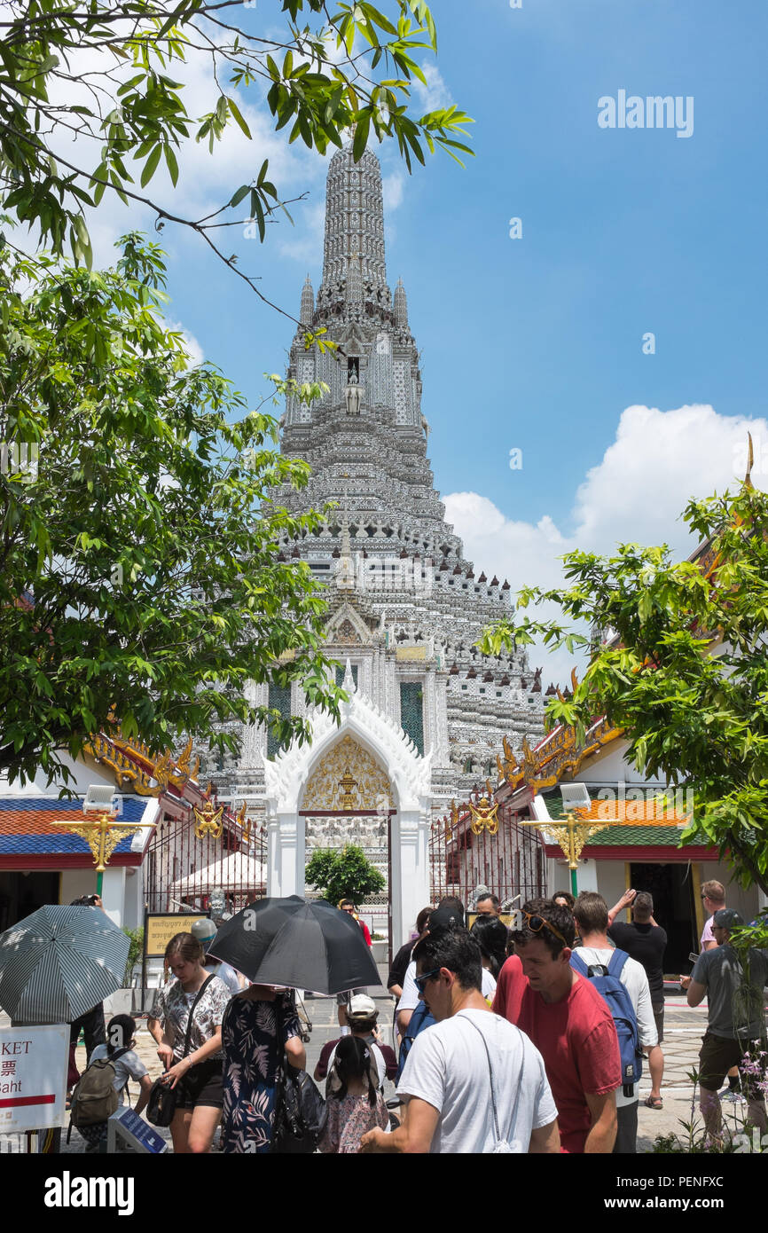 Visitors at Wat Arun or the Temple of Dawn on the bank of the Chao Phraya River in Bangkok, Thailand Stock Photo