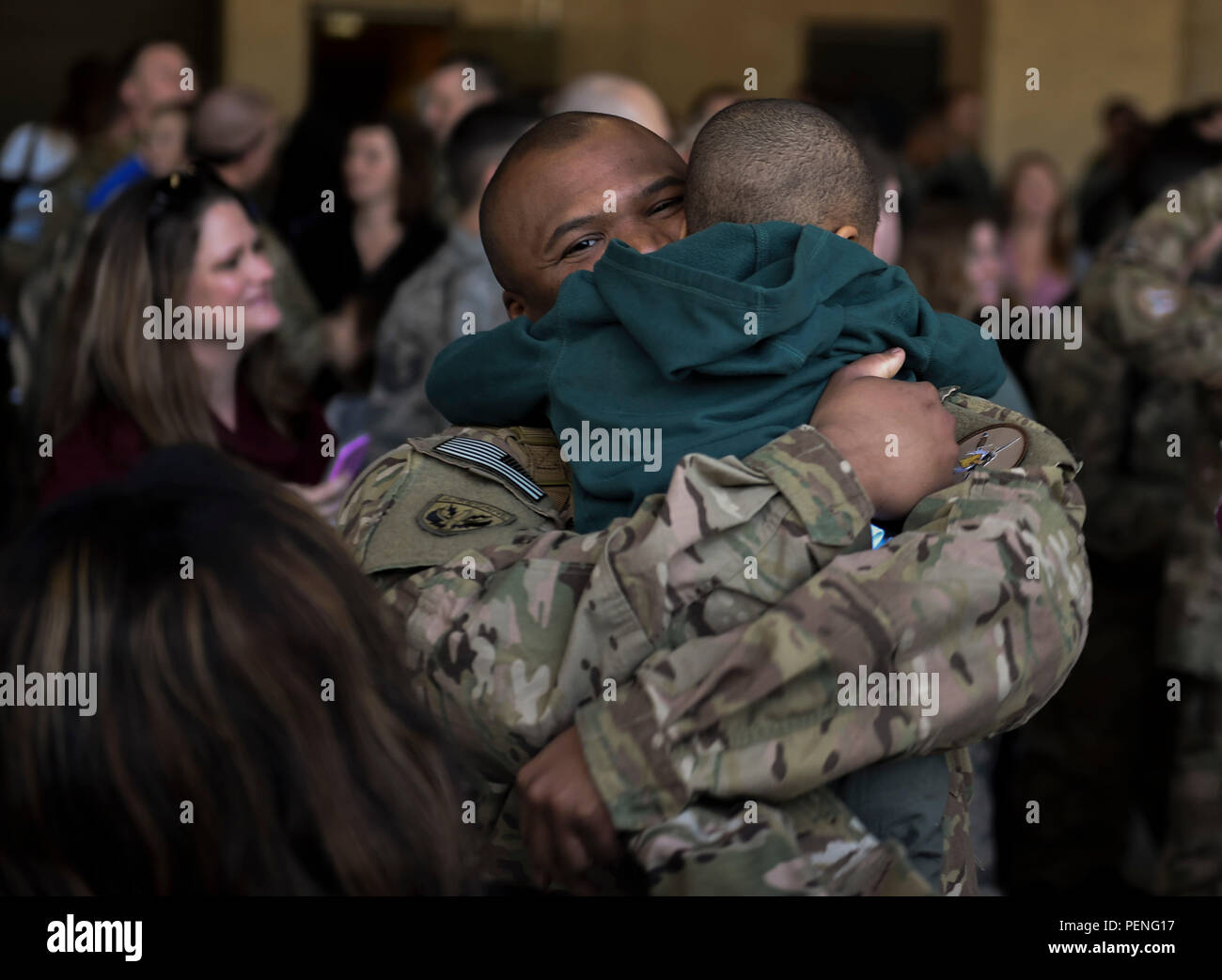 Stagg Sgt. Kenneth Redmon, an armament systems craftsman with the 1st Special Operations Aircraft Maintenance Squadron, reunites with his son during an Operation Homecoming at the Deployment Control Center on Hurlburt Field, Fla., Jan 13, 2016. The Operation Homecoming brought approximately 80 Airmen home from their deployment overseas.  (U.S. Air Force photo by Senior Airman Ryan Conroy) Stock Photo