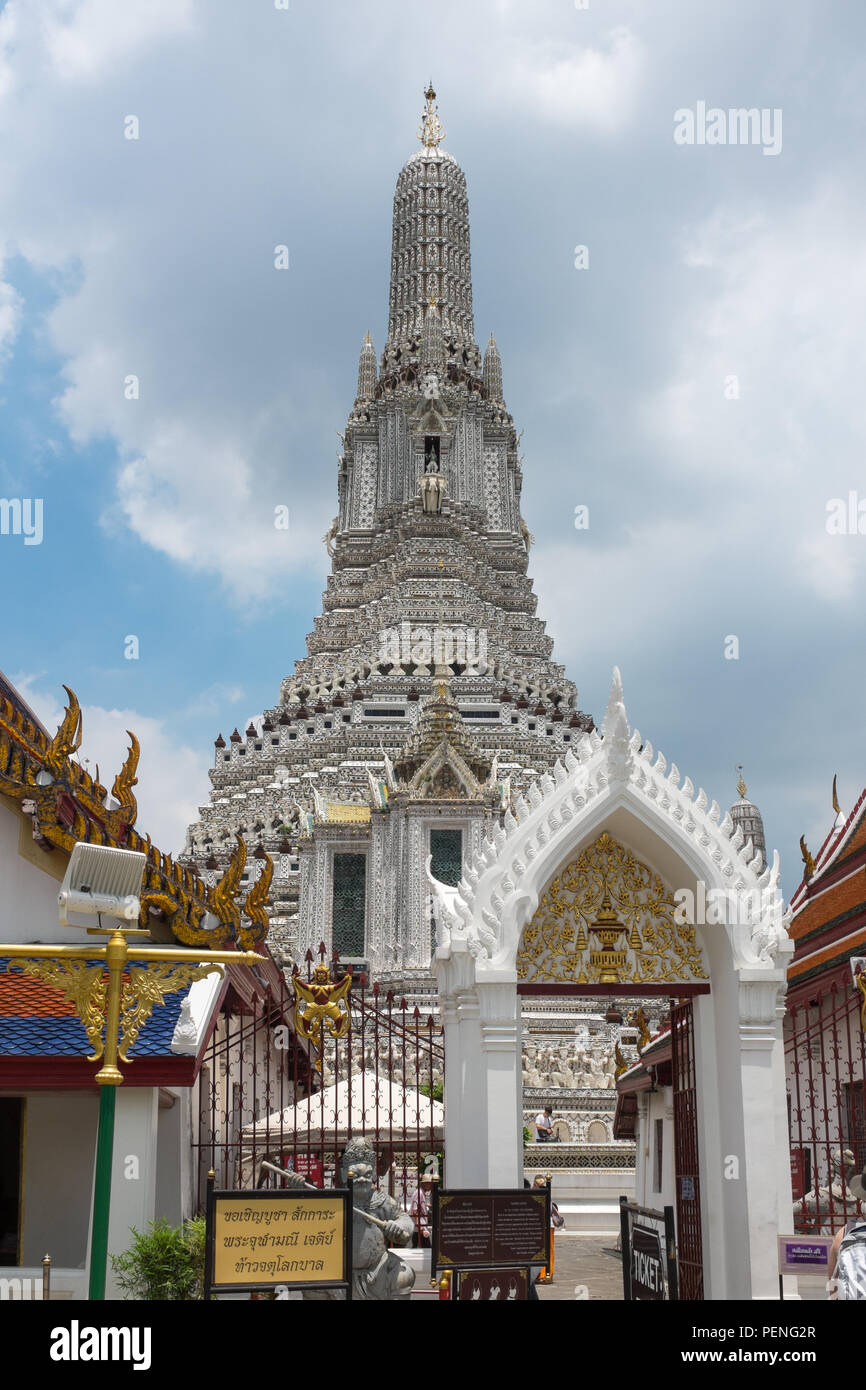 The entrance to Wat Arun or the Temple of Dawn on the bank of the Chao Phraya River in Bangkok, Thailand with the main prang or tower in view Stock Photo