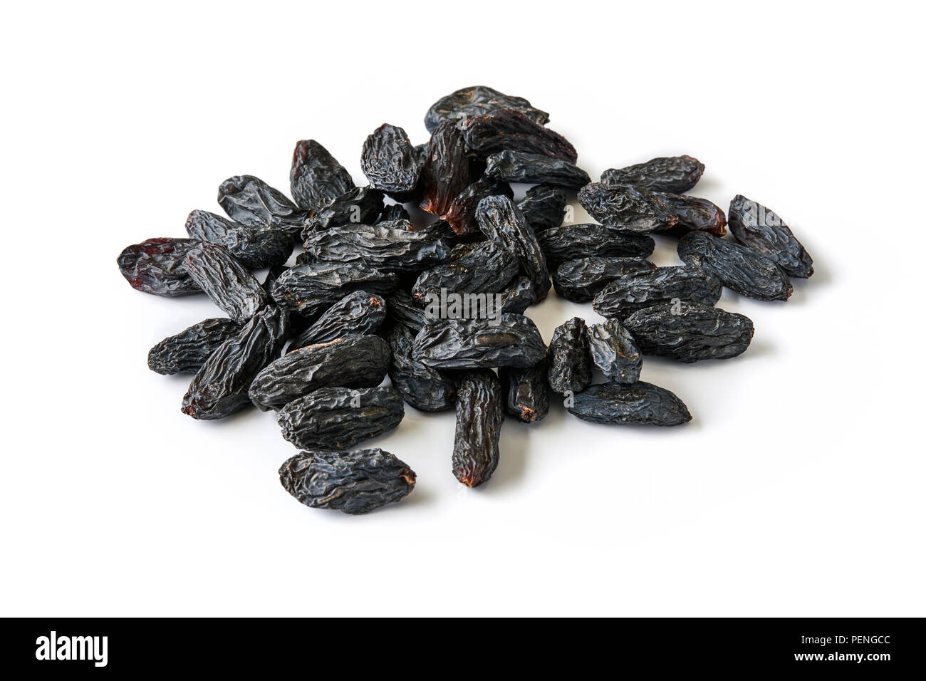 Heap of black raisins isolated on white background. Stock Photo