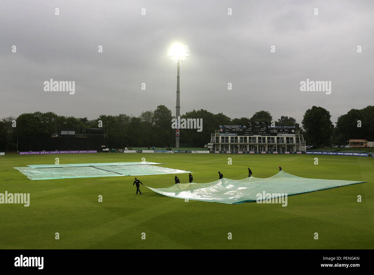 The covers come on as heavy rain stops plays during Kent Spitfires vs Essex Eagles, Royal London One-Day Cup Cricket at the St Lawrence Ground on 17th Stock Photo