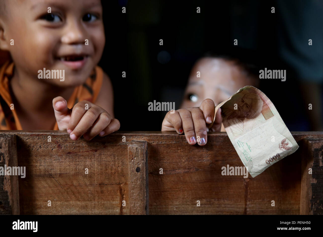 Kids showing off their rupiah Stock Photo