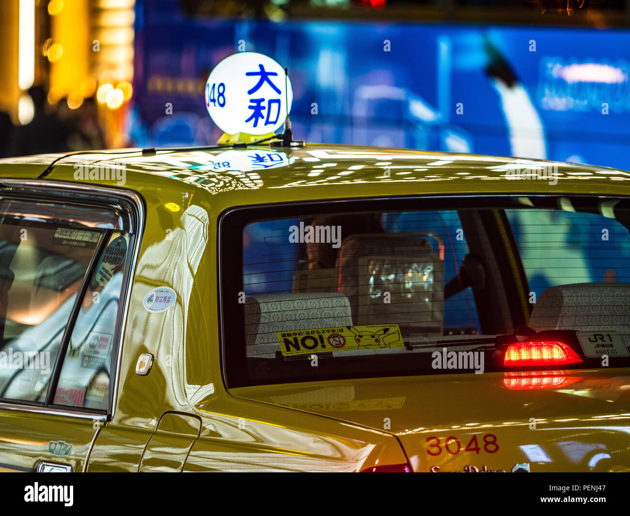Tokyo Taxi at dusk with illuminated sign Stock Photo
