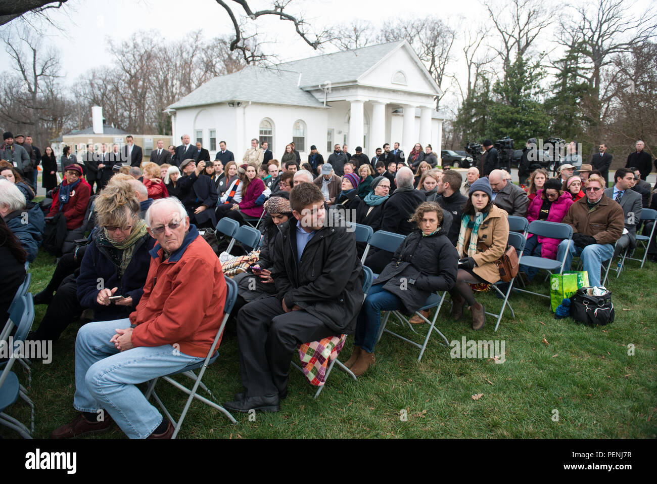 Attendees watch a bagpiper play during the Pan Am Flight 103 memorial ceremony in Arlington National Cemetery, Dec. 21, 2015, in Arlington, Va. A terrorist’s bomb destroyed the aircraft 27 years ago, in what became known as the “Lockerbie bombing,” killing 243 passengers, 16 crew members and 11 people on the ground. (U.S. Army photo by Rachel Larue/Arlington National Cemetery/released) Stock Photo