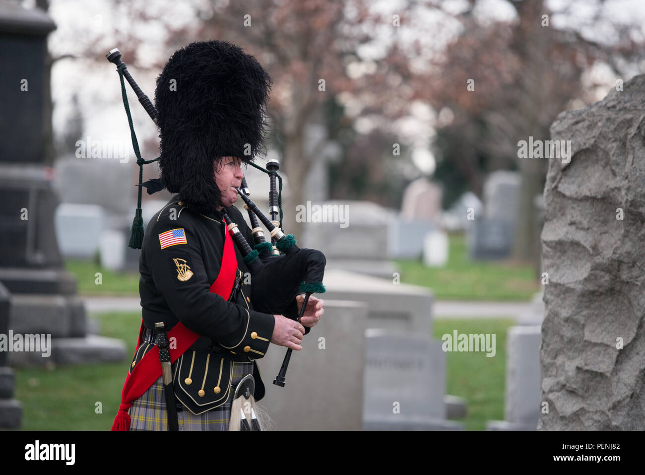 A bagpiper plays music during the Pan Am Flight 103 memorial ceremony in Arlington National Cemetery, Dec. 21, 2015, in Arlington, Va. A terrorist’s bomb destroyed the aircraft 27 years ago, in what became known as the “Lockerbie bombing,” killing 243 passengers, 16 crew members and 11 people on the ground. (U.S. Army photo by Rachel Larue/Arlington National Cemetery/released) Stock Photo