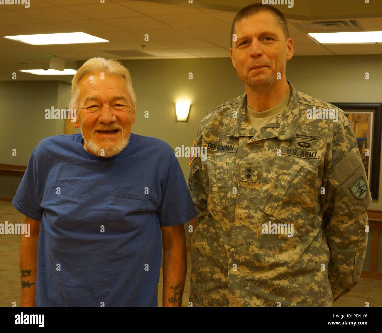 Maj. Gen. Al Dohrmann, North Dakota adjutant general, visits with Danny Mckinney, a resident of