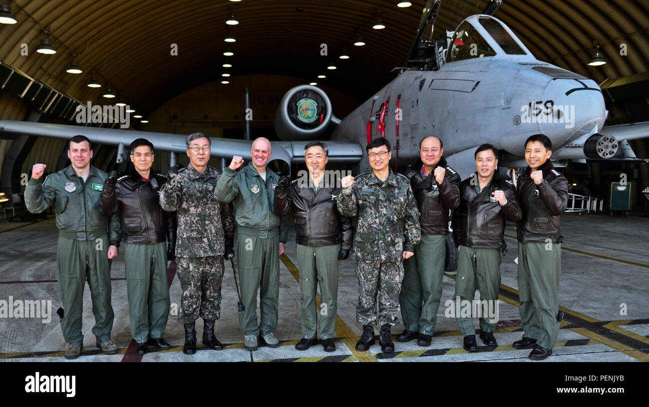 Senior leaders from the Republic of Korea Air Force Operations Command and 51st Fighter Wing pose in front of an A-10 Thunderbolt II during an immersion tour for ROKAF Lt. Gen. Lee, Wang Keun, AFOC commander, at Osan Air Base, ROK, Dec. 17, 2015. Senior leaders from the ROK AFOC toured the base to learn about the various aircraft, mission and capabilities the 51st FW supports on the peninsula. (U.S. Air Force photo/Tech. Sgt. Travis Edwards) Stock Photo