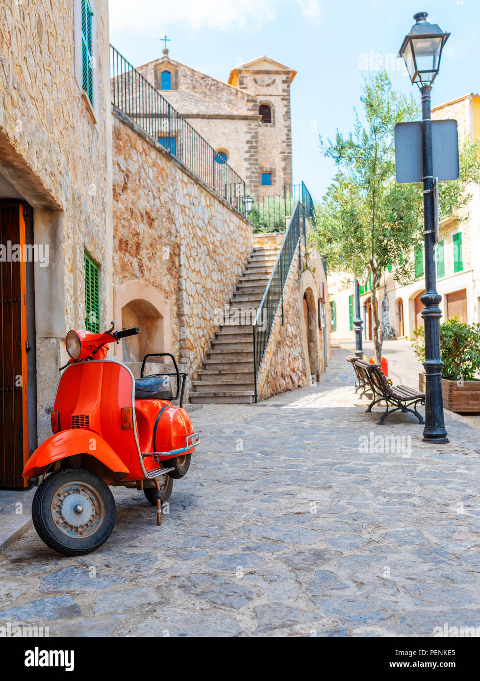 vintage red motor scooter parked in historic spanish village Stock Photo