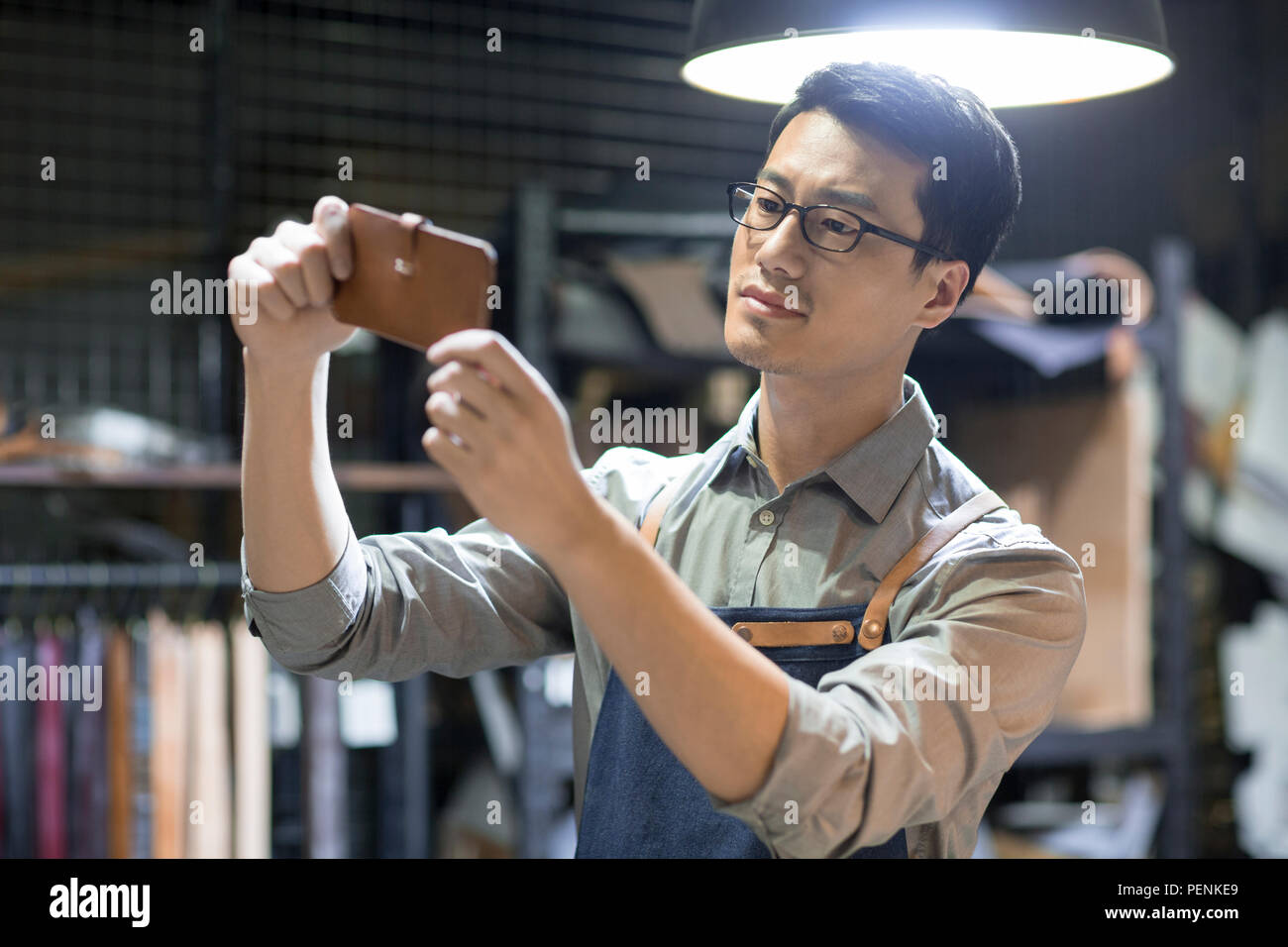 Young leather craftsman working in studio Stock Photo