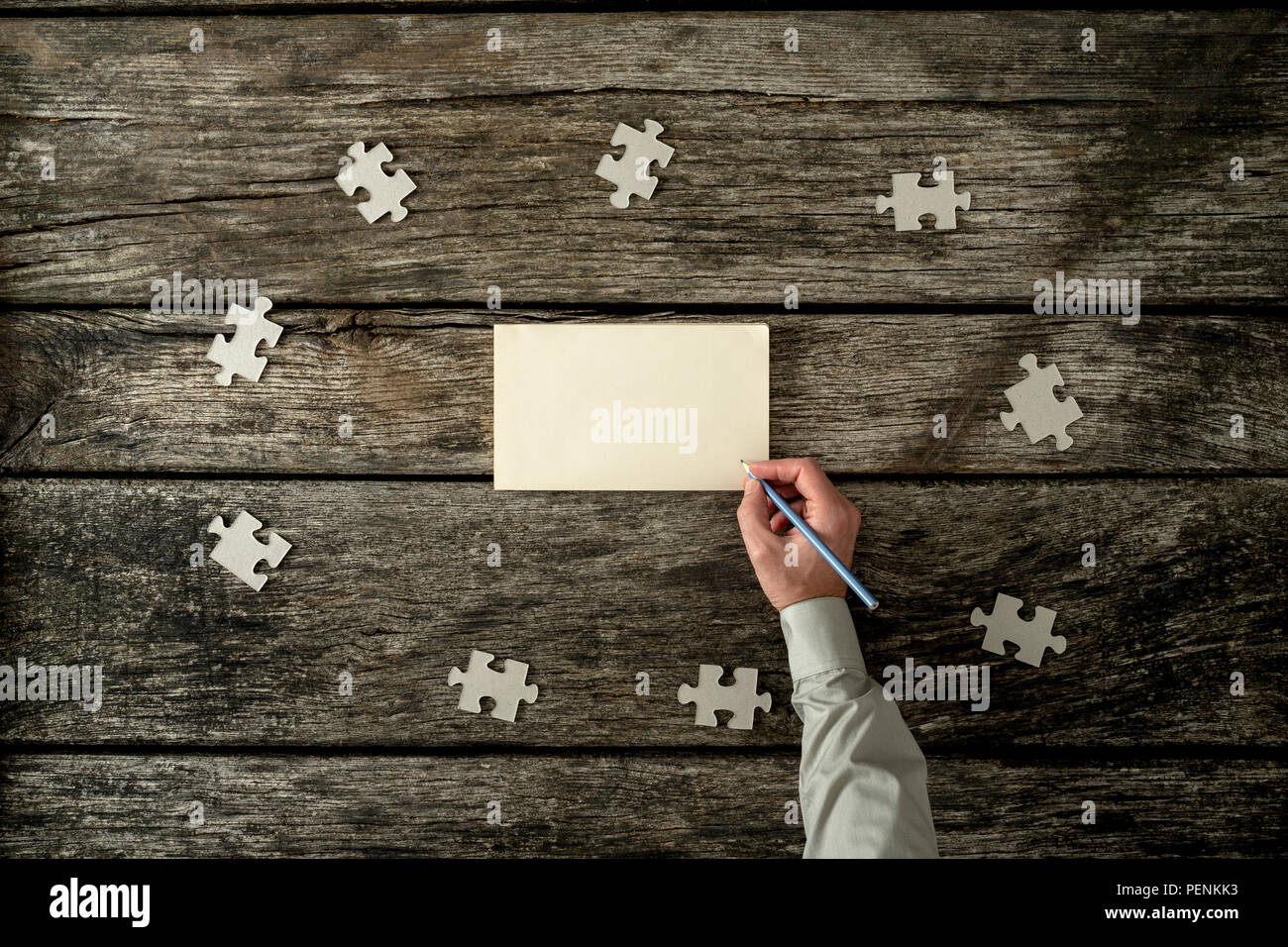 Top view of male hand writing on a blank paper lying on a textured ...