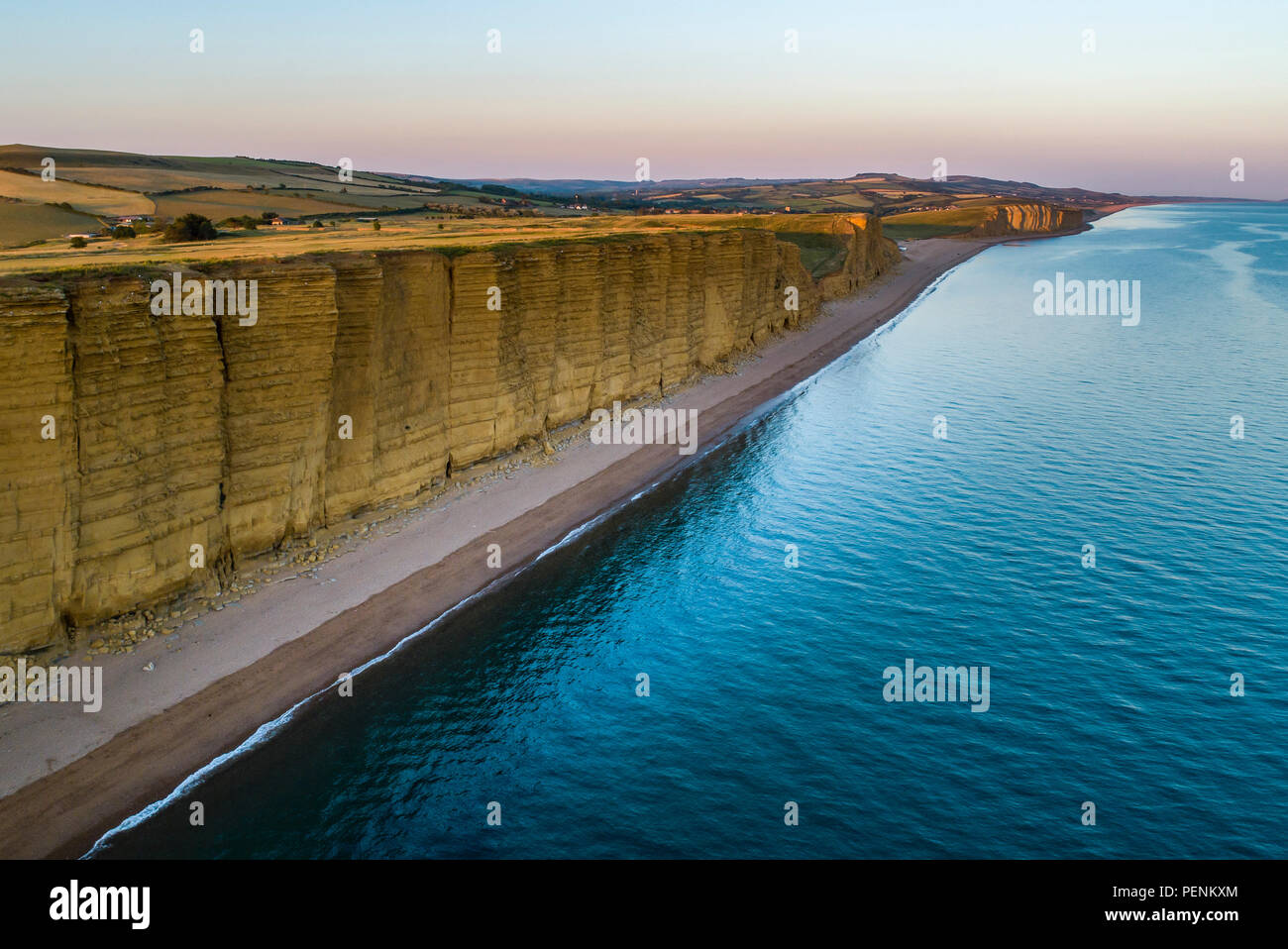 Drone image of hot of the beach and cliffs in West Bay Dorset during twilight. Stock Photo