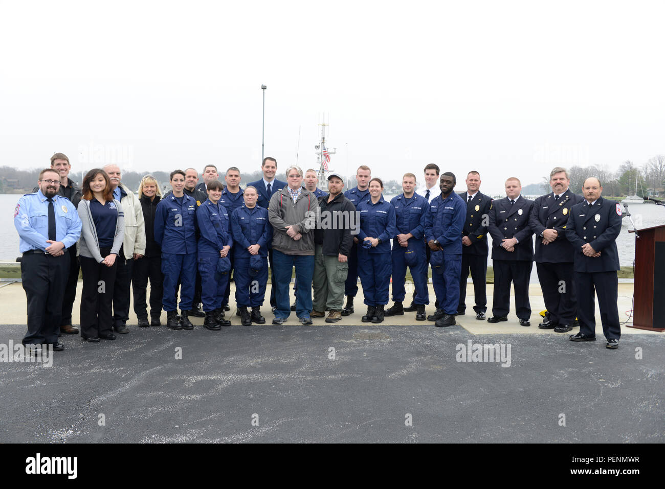 Brad Stemcosky and Charlie Frend, survivors of a capsized vessel incident, pose for a photo after a news conference reuniting them with their rescuers at Coast Guard Station Annapolis, Md., Wednesday, Dec. 30, 2015. The agencies involved were the U.S. Coast Guard, Maryland Natural Resources Police, Maryland State Police and Saint Mary's County. (U.S. Coast Guard photo by Petty Officer 3rd Class Jasmine Mieszala) Stock Photo