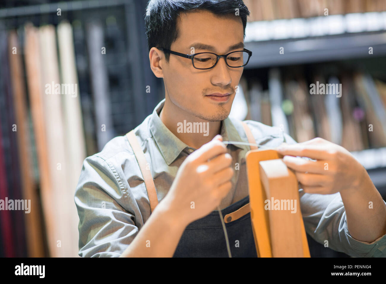 Young leather craftsman working in studio Stock Photo