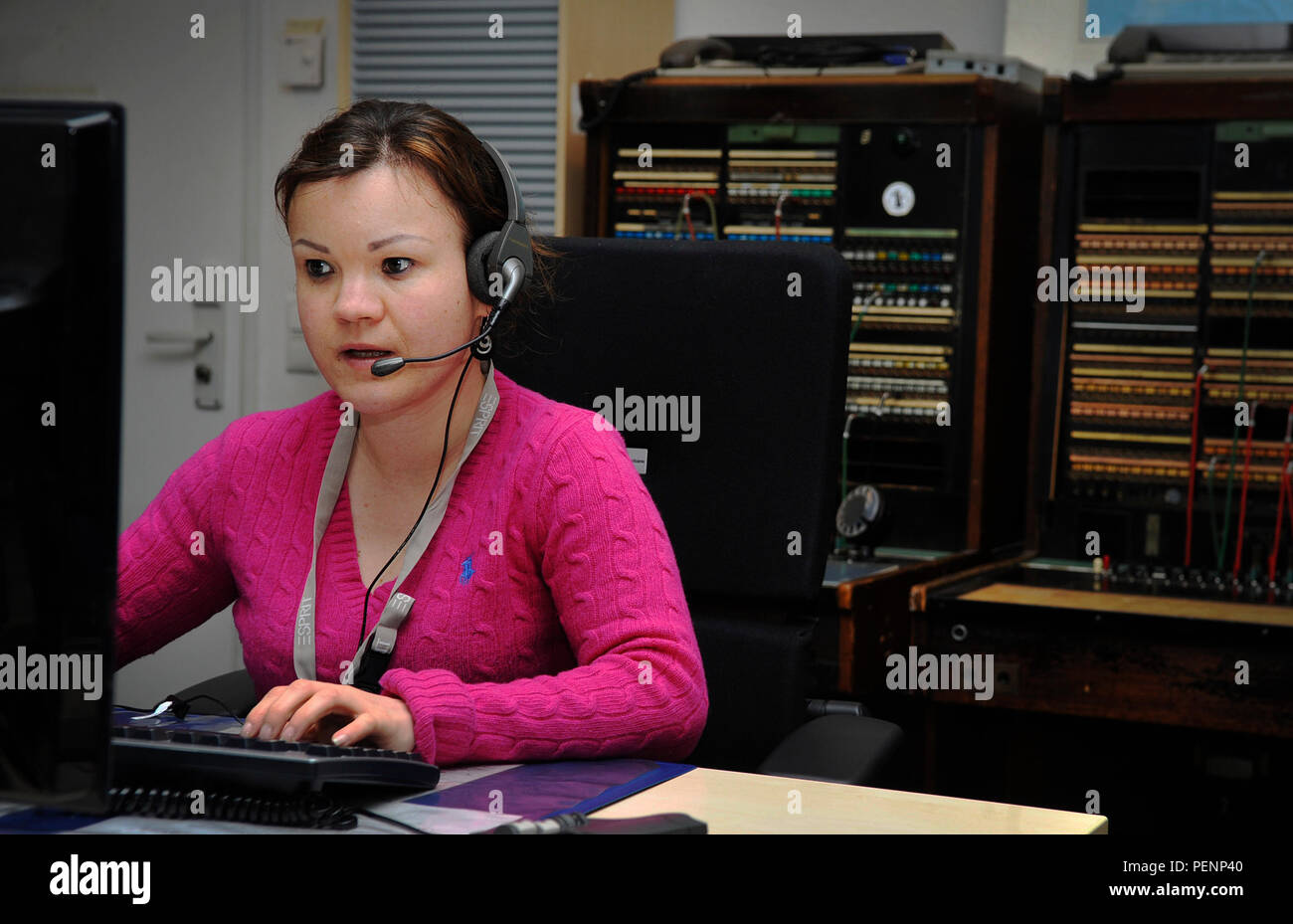 Verena Klein, 86th Communications Squadron consolidated switchboard operator, transfers a caller to the appropriate organization Jan. 4, 2015, at Ramstein Air Base, Germany. The operators answer more than 1.5 million calls annually and service the Air Force, Army, Navy, Marines and U.S. State Department personnel around the world. (U.S. Air Force photo/Airman 1st Class Larissa Greatwood) Stock Photo