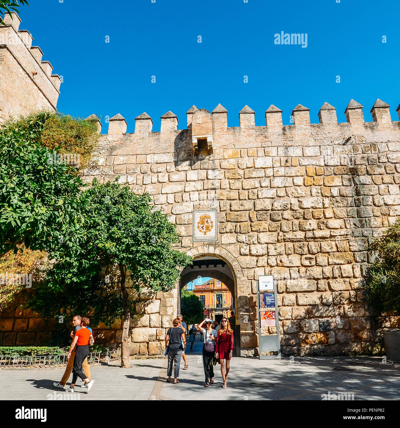 Seville, Spain - July 14th, 2018: Tourists at fortified entrance to the Alcazar Complex - UNESCO World Heritage Site Stock Photo