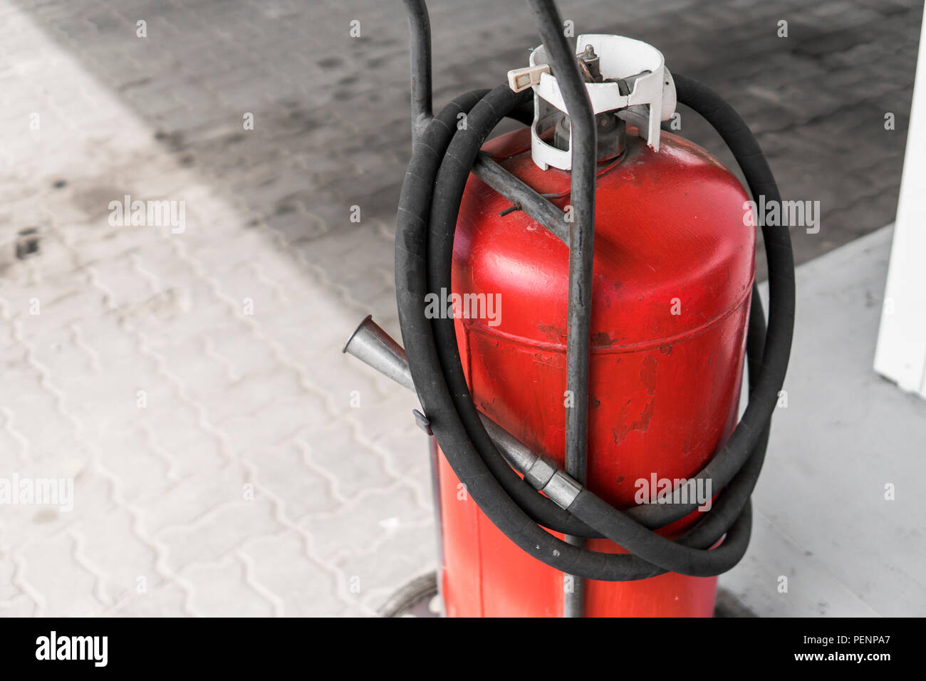 Red gas bottle cylinder with black tube Stock Photo