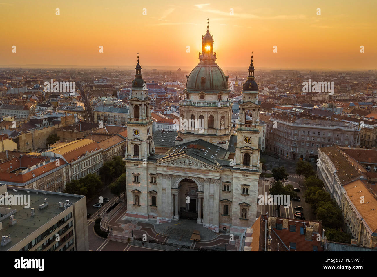 Budapest, Hungary - The rising sun shining through the tower of the beautiful St.Stephen's Basilica (Szent Istvan Bazilika) at sunrise on an aerial sh Stock Photo