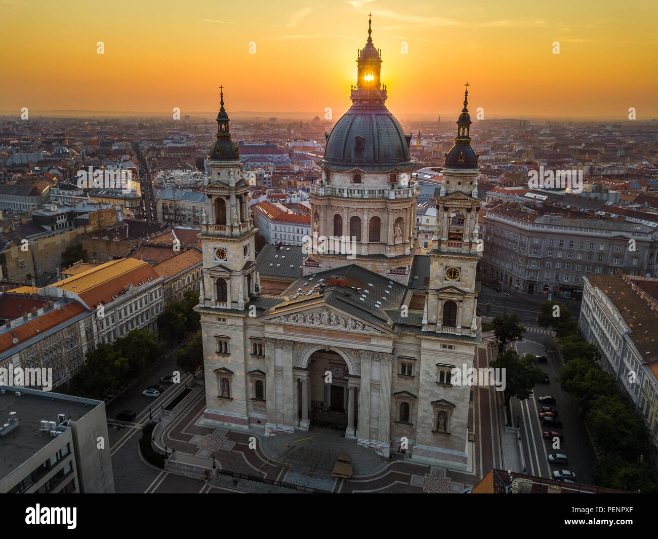 Budapest, Hungary - The rising sun shining through the tower of the beautiful St.Stephen's Basilica (Szent Istvan Bazilika) at sunrise on an aerial sh Stock Photo