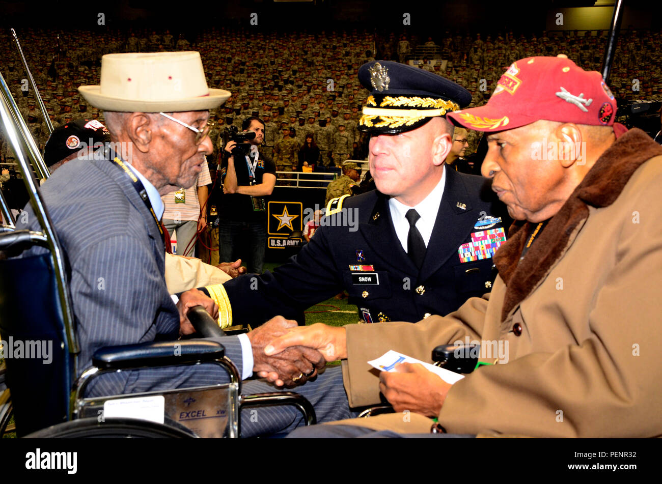 Richard Overton (left), America’s oldest veteran at 109 years old, greets Dr. Granville Coggs (right), a Tuskegee Airmen, and Maj. Gen. Jeffery Snow (center), commanding general of U.S. Army Recruiting Command, during the pre-game ceremonies of the 2016 U.S. Army All-American Bowl, Jan. 9. Overton delivered the game ball for the bowl, while Coggs was introduced to crowd with fellow Tuskegee Airmen Theodore Johnson during opening ceremonies. The AAB showcases the top 90 high school football players in the Nation, along with 125 top high school marching band and color guard. Stock Photo