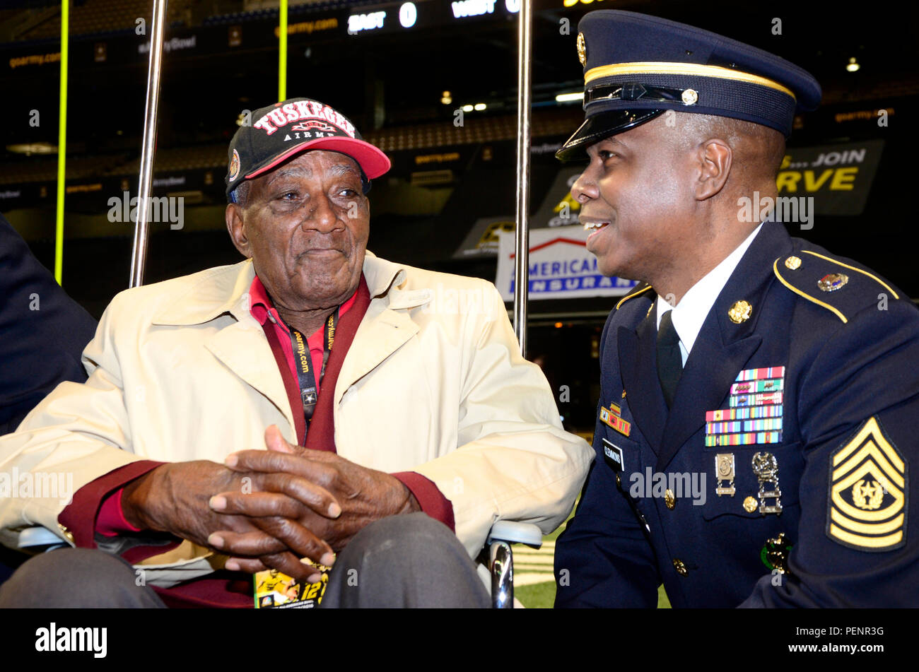 Theodore Johnson (left), one of few surviving Tuskegee Airmen, speaks with Command Sgt. Maj. Willie Clemmons (right), command sergeant major of the U.S. Army Recruiting Command, during the pre-game ceremonies of the 2016 All-American Bowl, Jan. 9. Johnson was introduced to a loud ovation at the 50-yard line prior to the opening kickoff. The AAB is U.S. Army sponsored bowl game that features the top 90 high school football players in the Nation. Current NFL players who participated in AAB in past years include, Andrew Luck, Adrian Peterson, and Odell Beckham Jr. Stock Photo