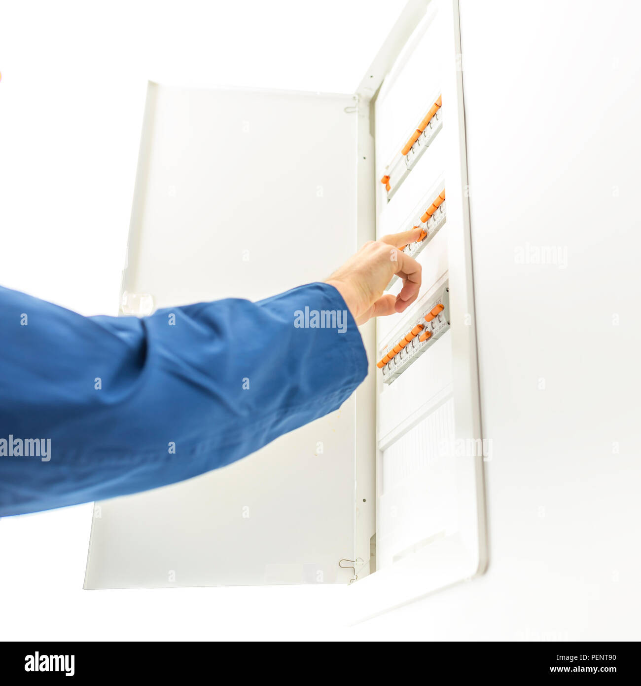 Man checking the electrical fuse box at his house to see if any of the