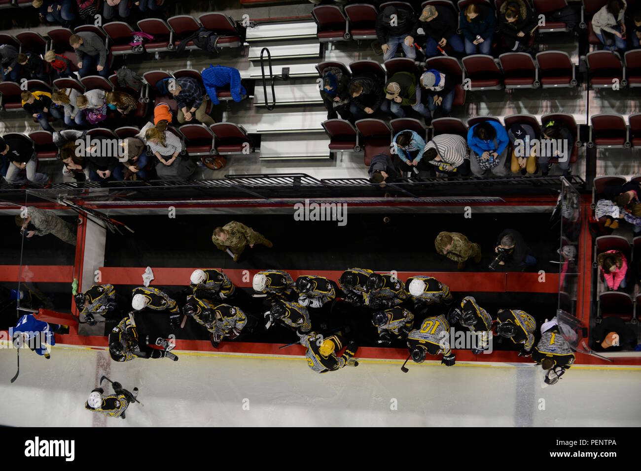 Members of the Army hockey team sit on the bench at the Joint Base