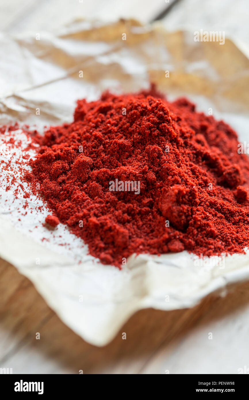Directly above shot of paprika powder on wooden spoon Stock Photo