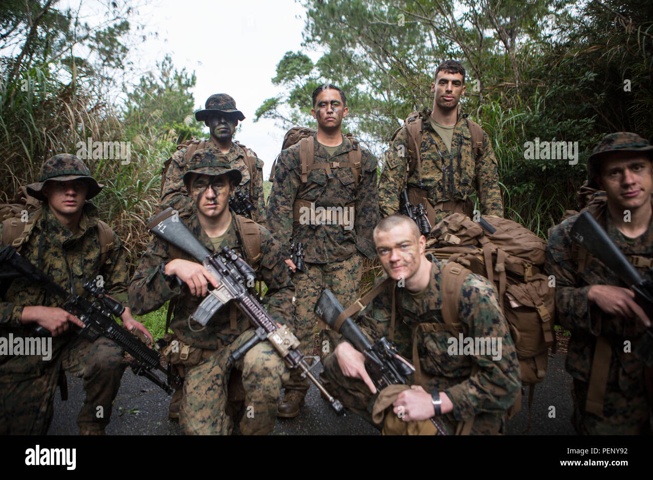 Sgt. Chad Nillo, top row, center, poses for a photo with his squad on Camp Hansen, Okinawa, Japan, Jan. 9, 2016. Sgt. Nillo is currently assigned to Alpha Company, Battalion Landing Team 1st Battalion, 5th Marines, 31st Marine Expeditionary Unit. Nillo has served with Alpha Co., BLT 1/5, 31st MEU, for the past 10 months and has had a great impact on the unit. Nillo is from Newark, California. (U.S. Marine Corps photo by Lance Cpl. Carl King Jr./Released) Stock Photo