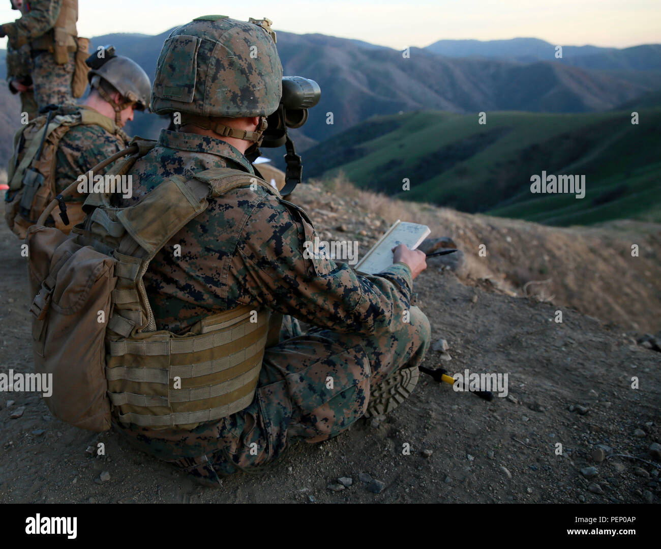 A Joint Fire Observer watches the impact of an 81 mm mortar round to