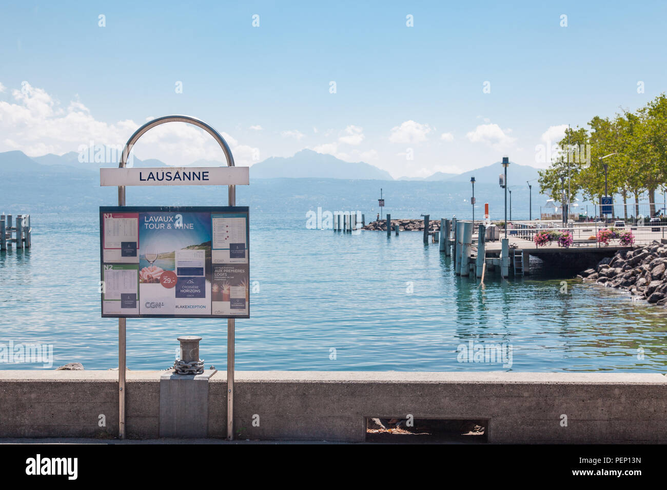 Information sign and ship timetable at pier in Lausanne Ouchy port, Switzerland on Lake Leman (Geneva Lake) on sunny summer day Stock Photo