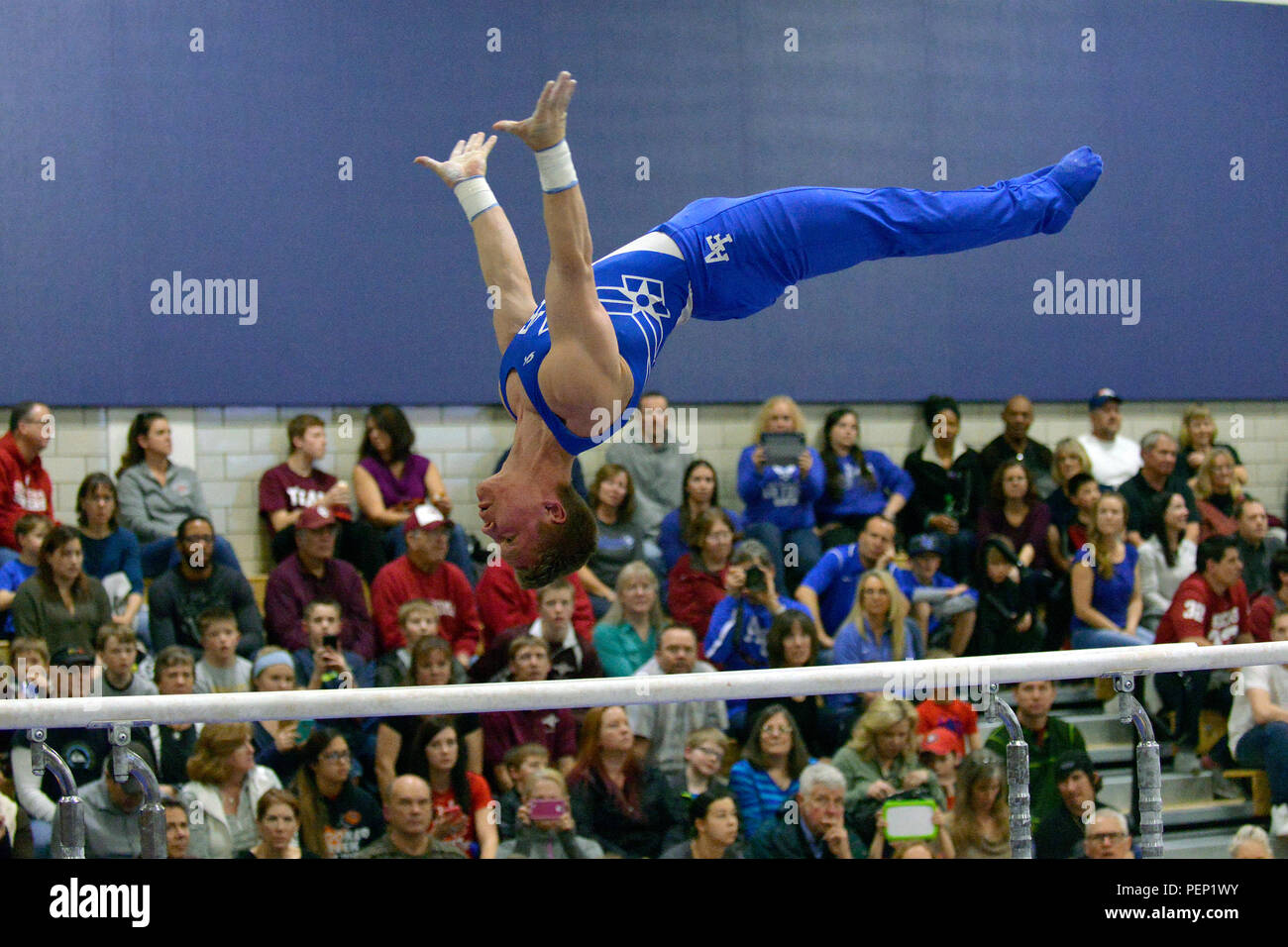 Eric Klein, a freshman, performs on the parallel bars during the Rocky