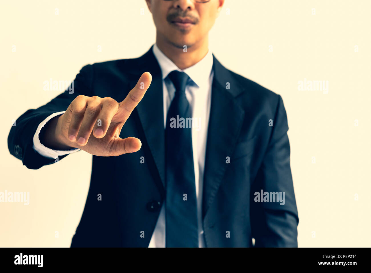 Businessman pointing his finger in cross process color. Stock Photo