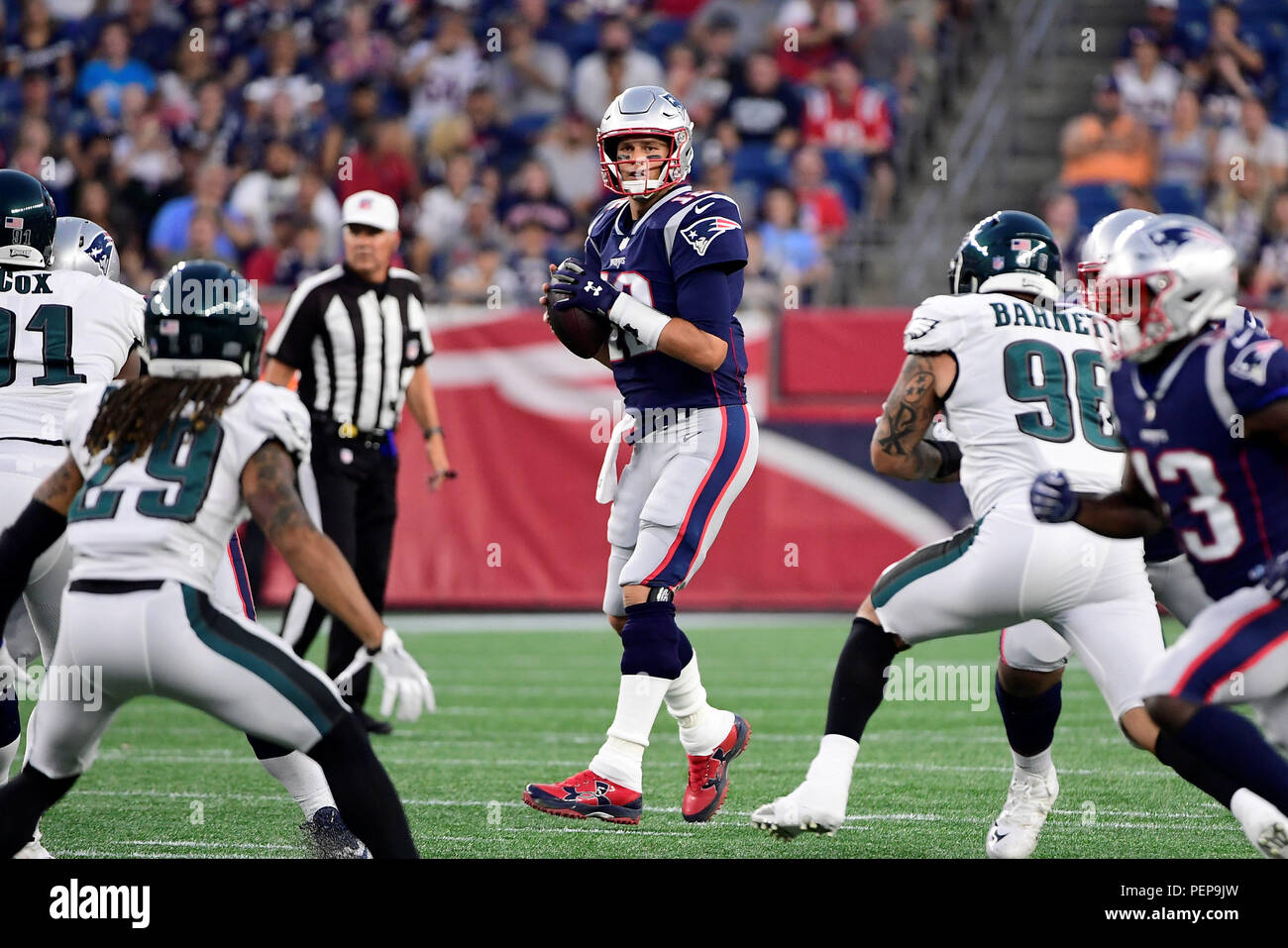 Foxborough, Massachusetts, USA. August 16, 2018: New England Patriots  quarterback Tom Brady (12) works in the pocket during the NFL pre-season  football game between the Philadelphia Eagles and the New England Patriots