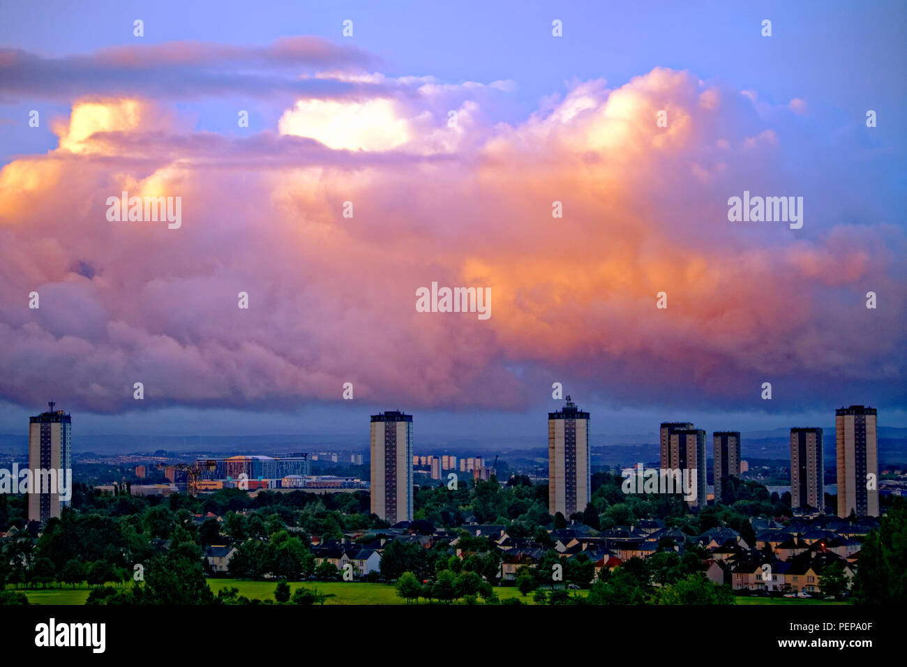 Glasgow, Scotland, UK. 17th August, 2018. UK Weather: Dright day ahead with fluffy cumulus clouds ahead of storm Ernesto due over the weekend as cauliflower cheese topped formations appear over the city’s southern high rises and queen Elizabeth university hospital   as sunrise tries to break through the highly dense sky in the east. Gerard Ferry/Alamy news Credit: gerard ferry/Alamy Live News Stock Photo