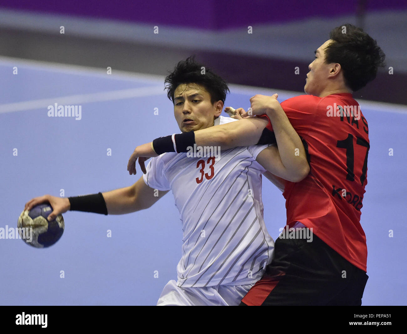 Jakarta. 17th Aug, 2018. Agarie Yuto (L) of Japan competes during the Men's Handball Preliminary Round Group B match between Japan and South Korea at the Asian Games 2018 in Jakarta, Indonesia on Aug. 17, 2018. The match ended with a 26-26 draw. Credit: Li He/Xinhua/Alamy Live News Stock Photo