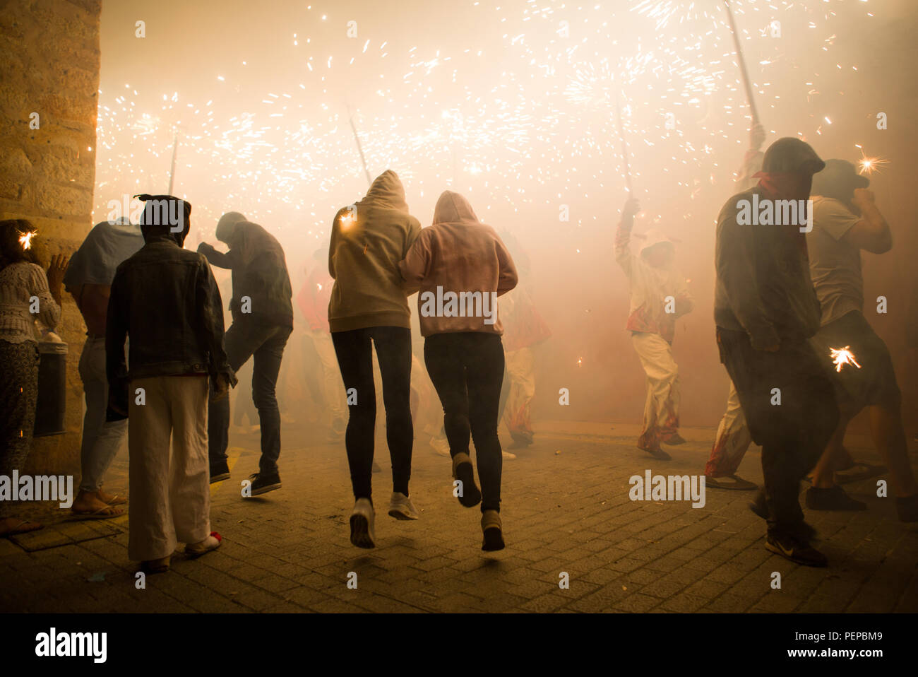 Alaró, Spain, 16th August, 2018. Locals and foreigners dance together under the sparks made by firecrackers in the town of Alaró, Spain. Credit: Gergő Lázár/Alamy Live News Stock Photo