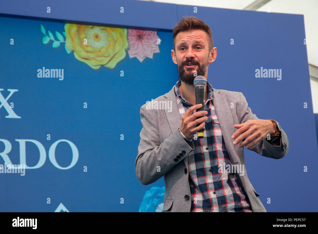 Southport, Merseyside, UK. 17th Aug, 2018. Max McMurdo, British designer, upcycler, upcycle junk, entrepreneur and TV presenter talking in the celebrity theatre at Southport Flower Show, as exhibitors, garden designers, and floral artists wow the visitors to this famous annual event. Credit: MediaWorldImages/Alamy Live News Stock Photo