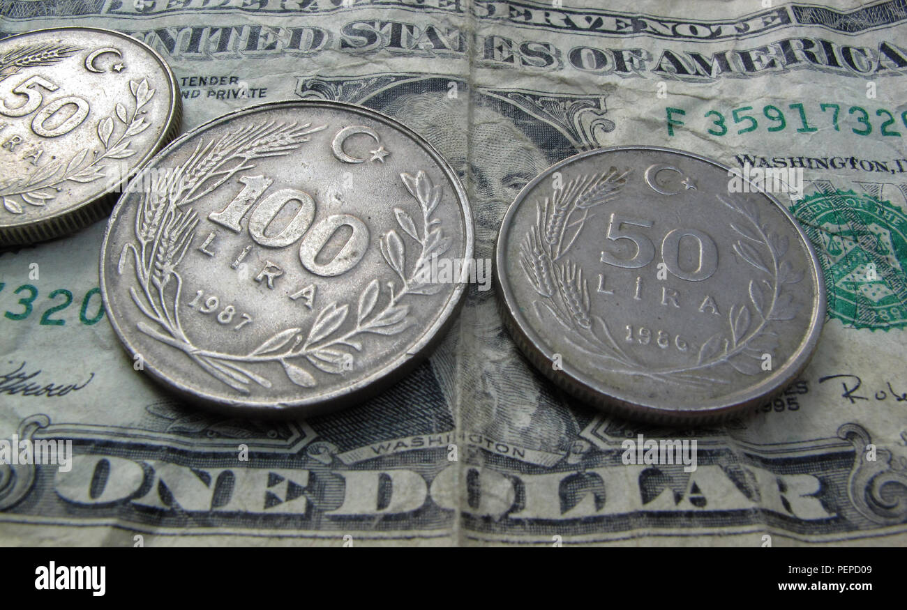 Kaufbeuren, Germany. 17th Aug, 2018. Turkish lira coins are lying on an American one dollar note. After several days of recovery, the Turkish national currency, the lira, fell sharply again on Friday. At noon, the currency fell by up to just under eight percent against the US dollar. Credit: Karl-Josef Hildenbrand/dpa/Alamy Live News Stock Photo