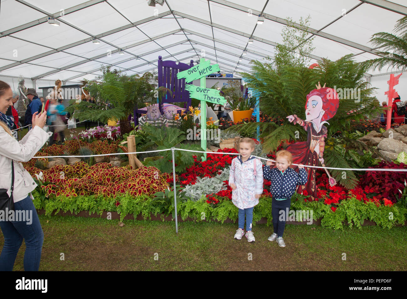 Children at Southport, Merseyside, UK. 17th Aug, 2018. The Queen of hearts points to visitors at Southport Flower Show as entertainers, exhibitors, garden designers, and floral artists wow the visitors to this famous annual event. Credit; MediaWorldImages/AlamyLiveNews Stock Photo