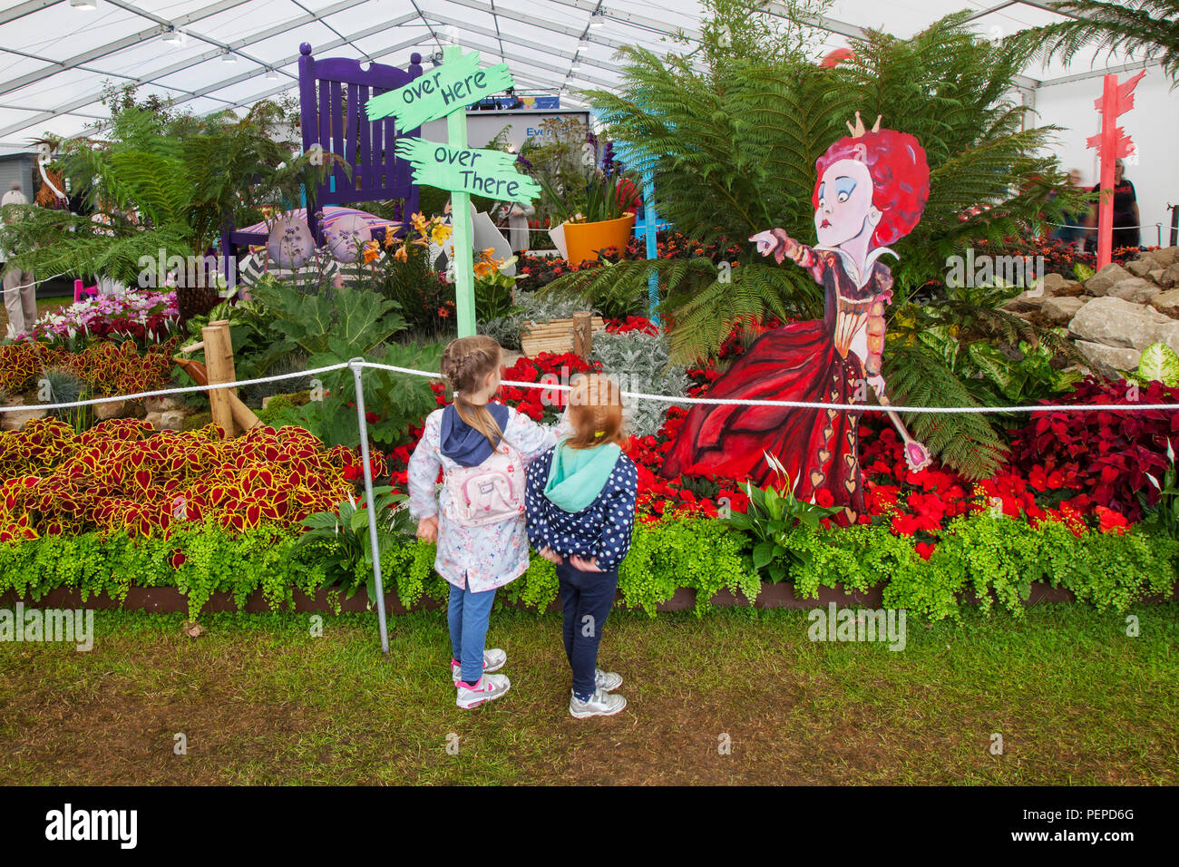 Children at Southport, Merseyside, UK. 17th Aug, 2018. The Queen of hearts points to visitors at Southport Flower Show as entertainers, exhibitors, garden designers, and floral artists wow the visitors to this famous annual event. Credit; MediaWorldImages/AlamyLiveNews Stock Photo