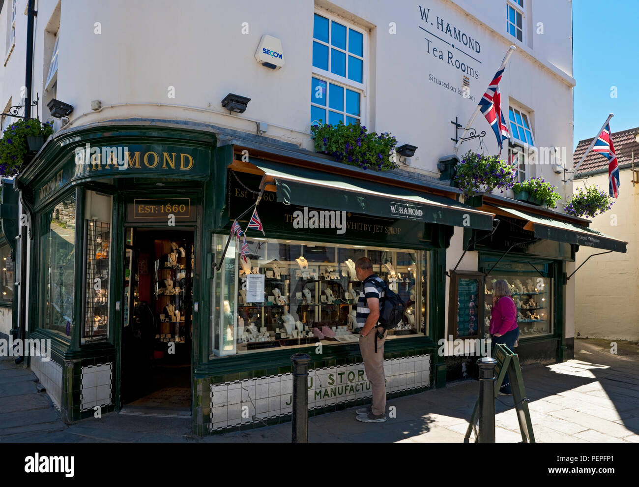 People tourists visitors looking in window of The Original Whitby Jet