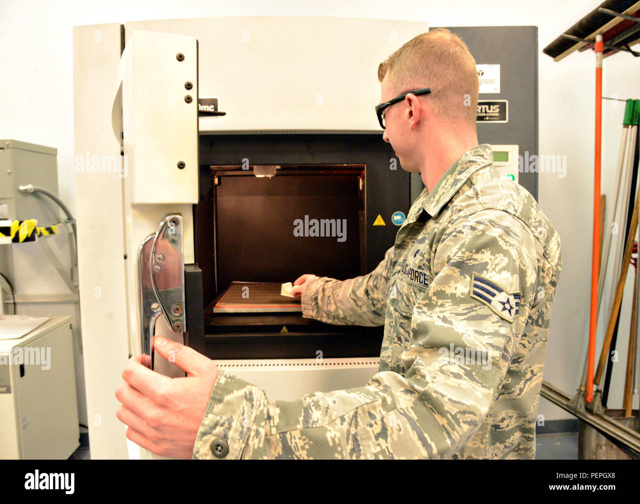 Senior Airman Jordan Brown, an aircraft metals technician, uses the Fortus 400mc, a 3-D printer, in the 552nd Maintenance Squadron’s Fabrications Flight. (Air Force photo by Kelly White) Stock Photo