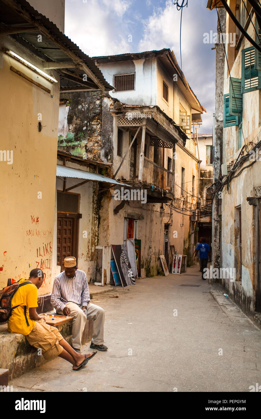 Stone Town, Zanzibar, 20 May - 2015: Men playing dominoes in alleyway. Stock Photo