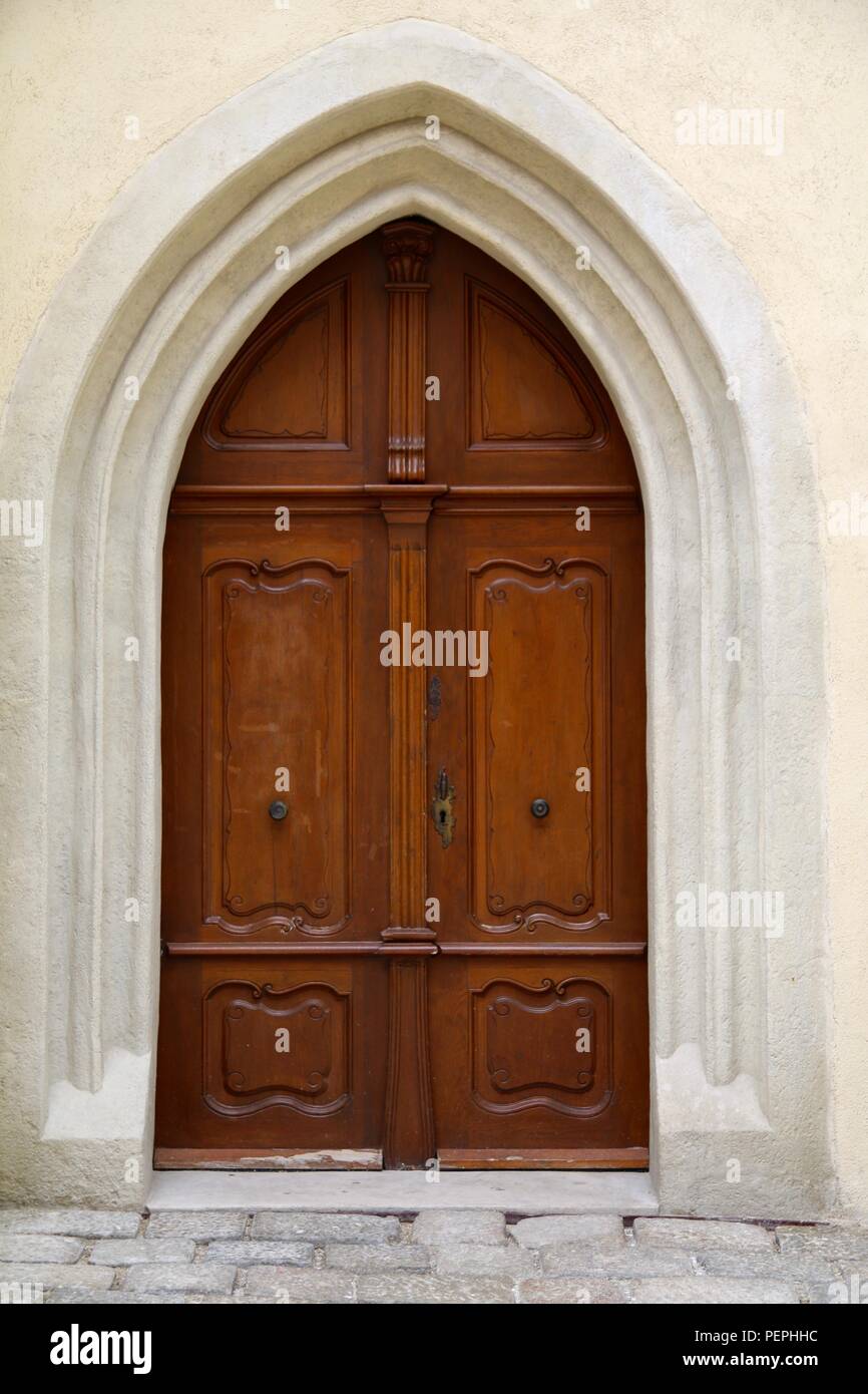 Double Wooden Doors In An Arched Doorway Stock Photo