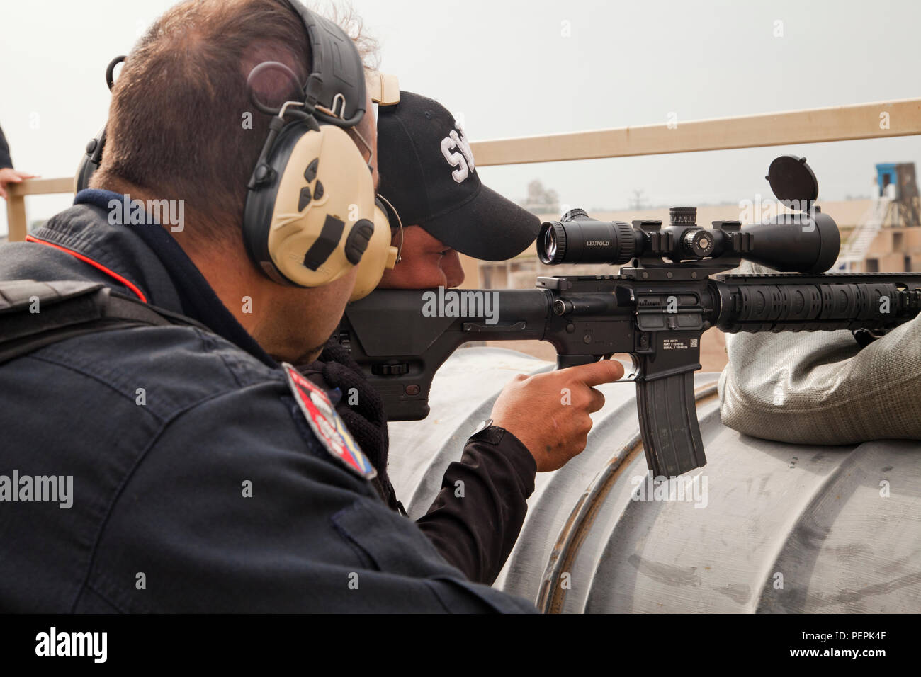 An Italian Carabinieri officer coaches an Iraqi policeman as he fires an  M16 rifle during advanced marksmanship training at Camp Dublin, Iraq, Jan.  23, 2016. The Carabinieri are training Iraqi policemen as