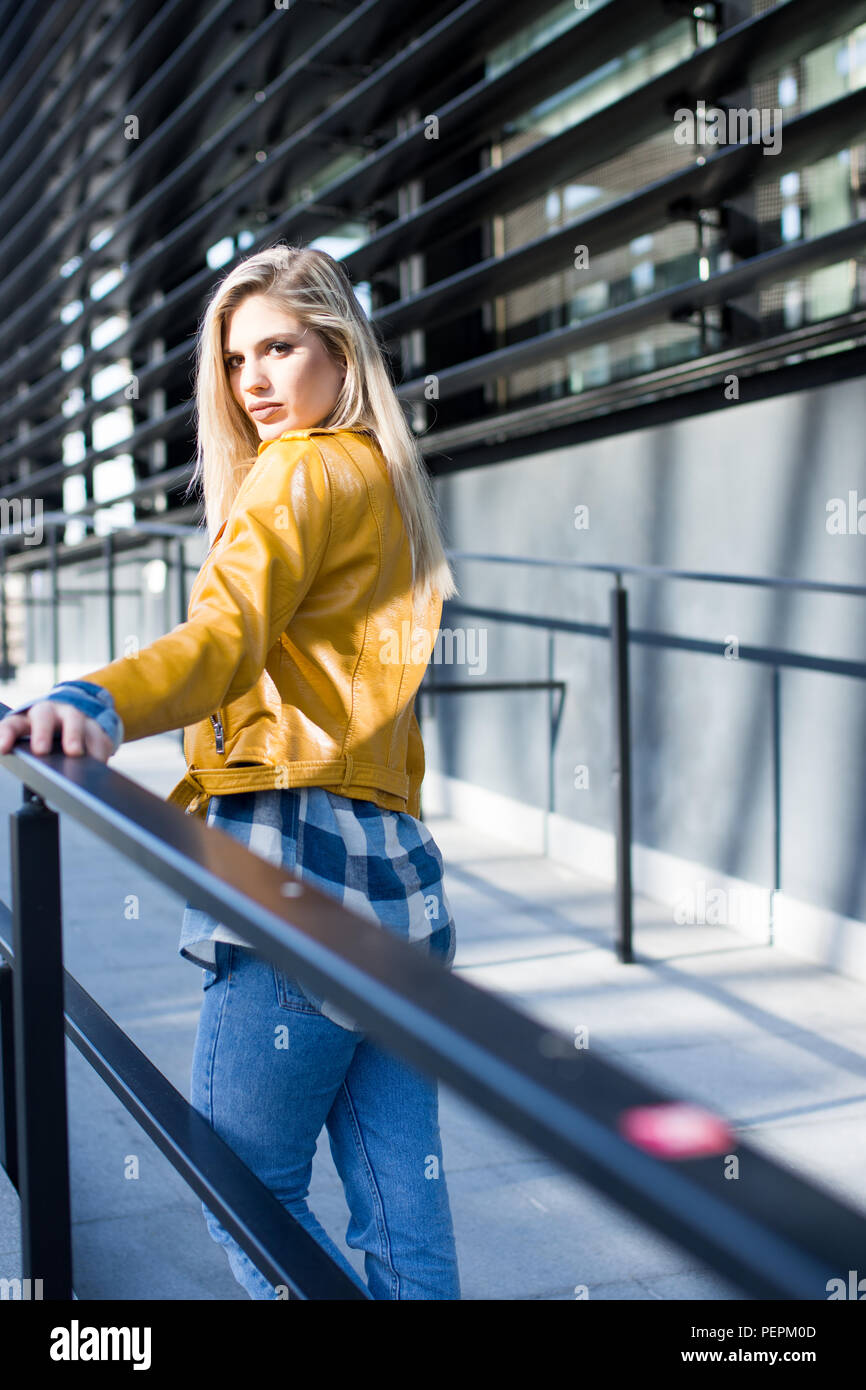 stylish girl in yellow leather jacket Stock Photo