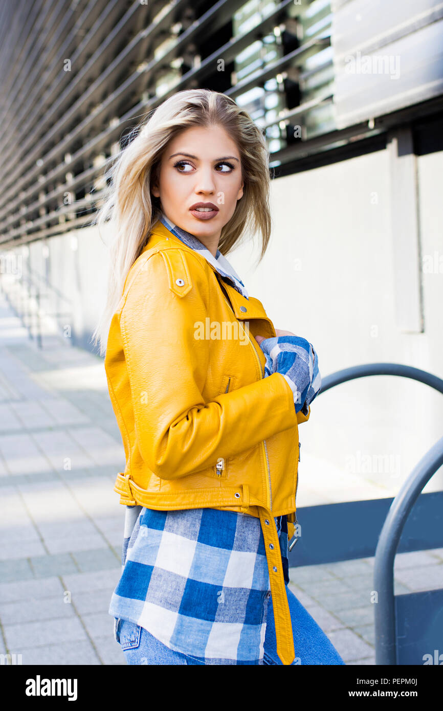 stylish girl in yellow leather jacket Stock Photo