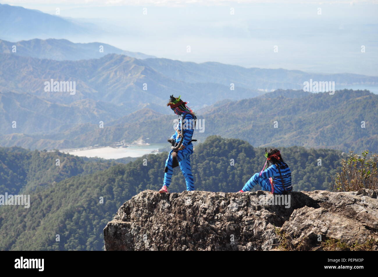 2 young avatar girls Keytiri & Feytiri from Pandora, arriving at mt. Ulap from a long journey down to earth,& enjoying the high-noon sun Stock Photo