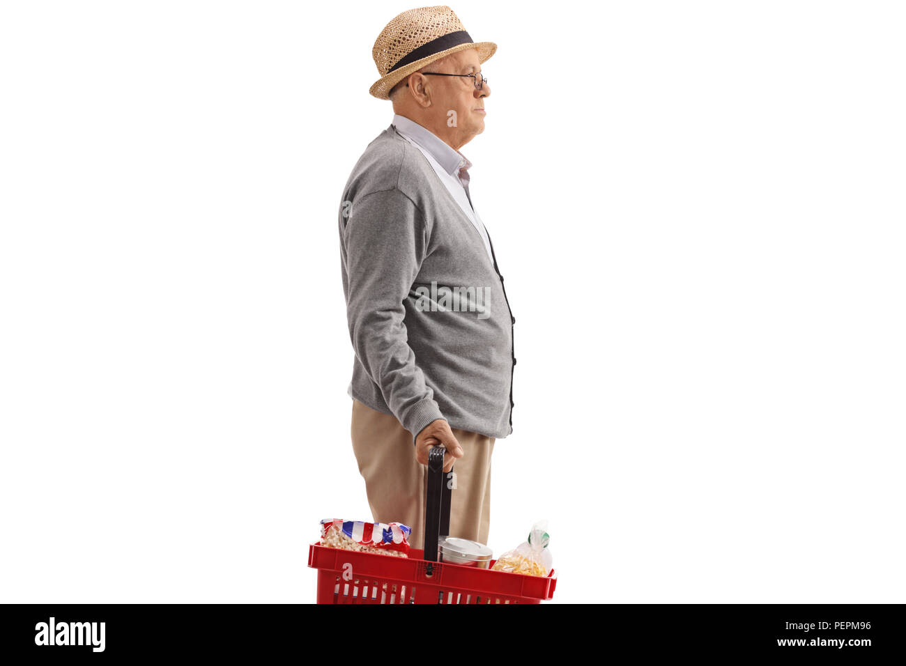 Profile shot of a senior with a shopping basket isolated on white background Stock Photo