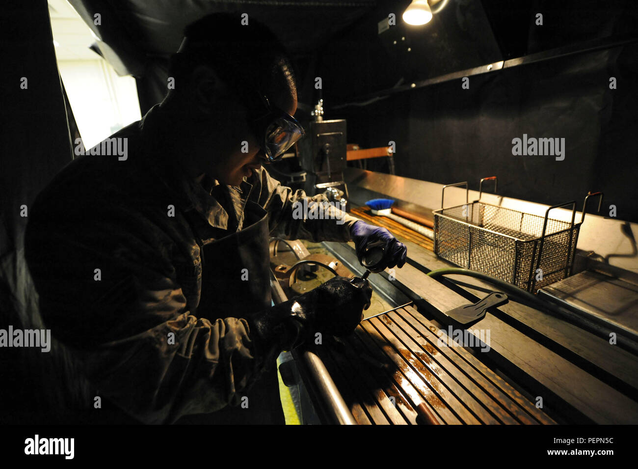 Senior Airman Max Bustamante, 22nd Maintenance Squadron non-destructive inspection Airman, checks the amount of magnetic current emanating from a part, Jan. 25, 2016, at McConnell Air Force Base, Kan. NDI-Airmen run an electric current through aircraft parts to demagnetize the part so that it does not interfere with the compass on the aircraft while in flight. (U.S. Air Force photo/Airman Jenna K. Caldwell) Stock Photo